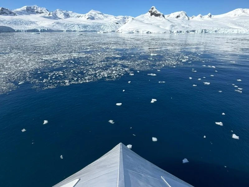 View over the bow of MV Greg Mortimer towards the Antarctic Peninsula
