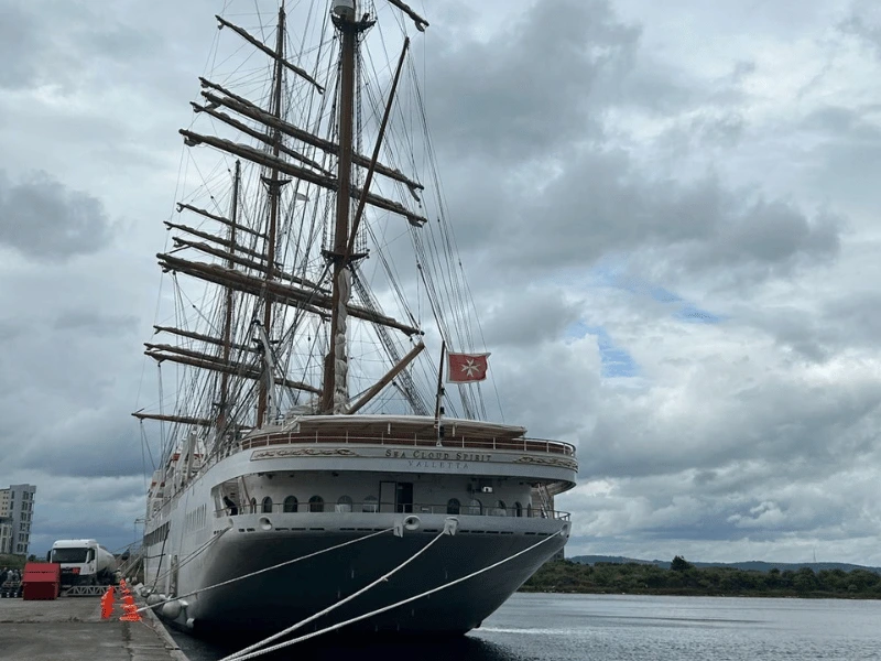 Sea Cloud Spirit docked beside a quay beneath a cloudy sky