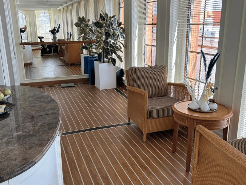 Bright wellness area aboard Sea Cloud Spirit with seating, exercise equipment and large windows