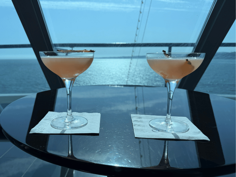 Two cocktails overlooking the ocean in Horizons Lounge aboard Oceania Cruises' Sirena.