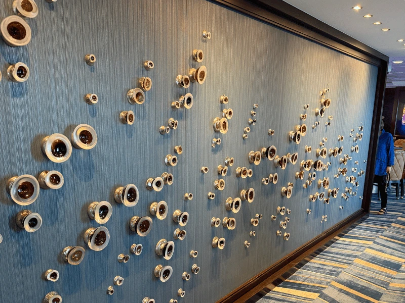 Decorative wall art in a public corridor aboard Oceania Sirena.