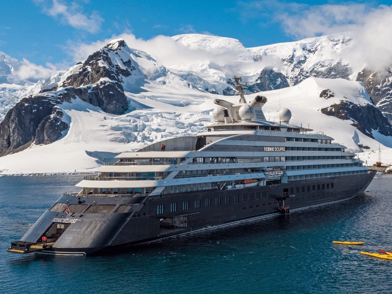 Scenic Eclipse expedition ship sailing beside snow-covered mountains