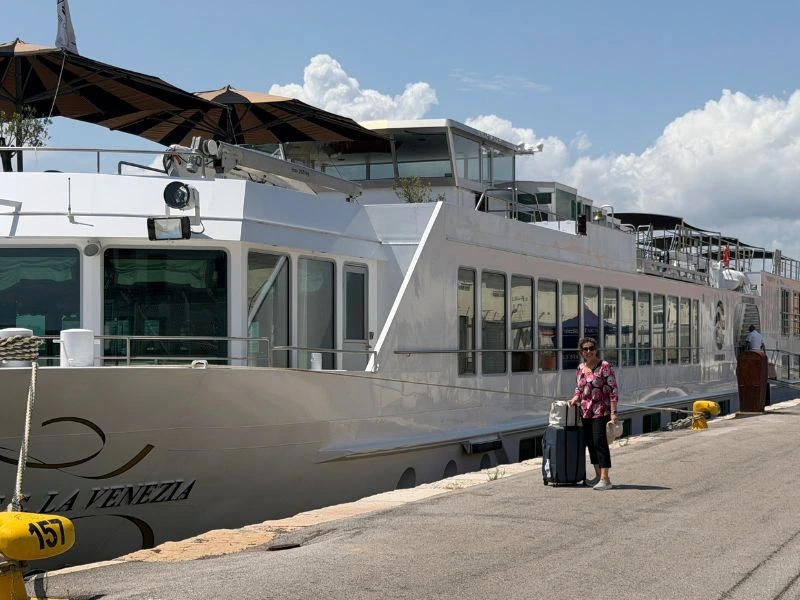 Ann Anglesea standing beside Uniworld’s S.S. La Venezia before her Venice cruise
