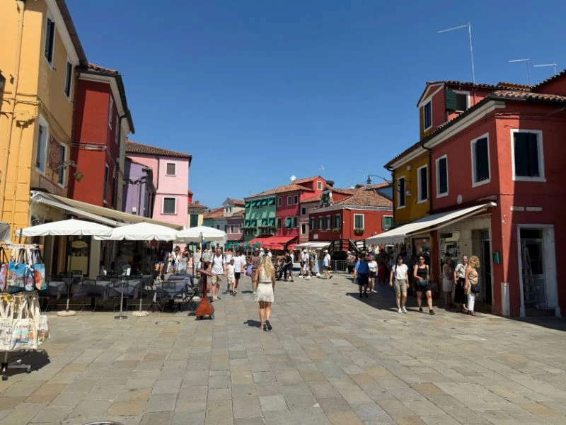 Colourful houses and shops lining a pedestrian street on Burano