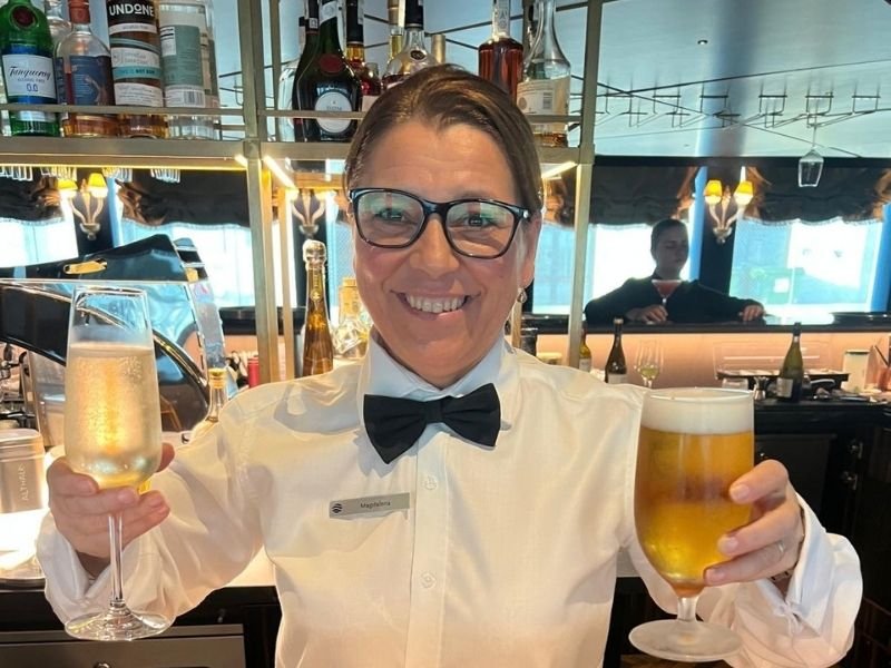 Magdalena serving drinks behind Hari’s Bar aboard S.S. La Venezia